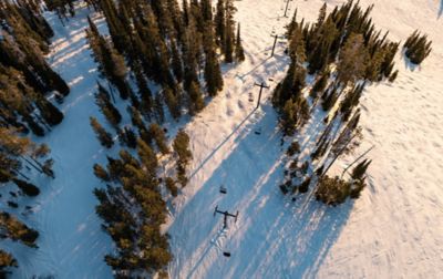 shot from above of a ski hill and chairlift. 
