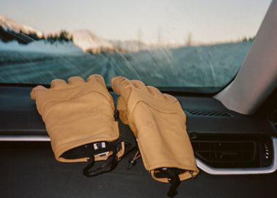 Gloves on the dash with a snowy road ahead.