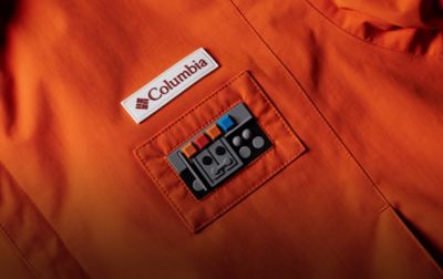 Close-up detail of raised-silicone comm link and logo patches. 