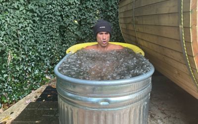 Pro trail runner Yassine Diboun sits in his homemade ice bath in his backyard. 