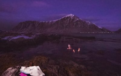 Rachel Pohl cold plunges in the icy ocean just after sunset.  