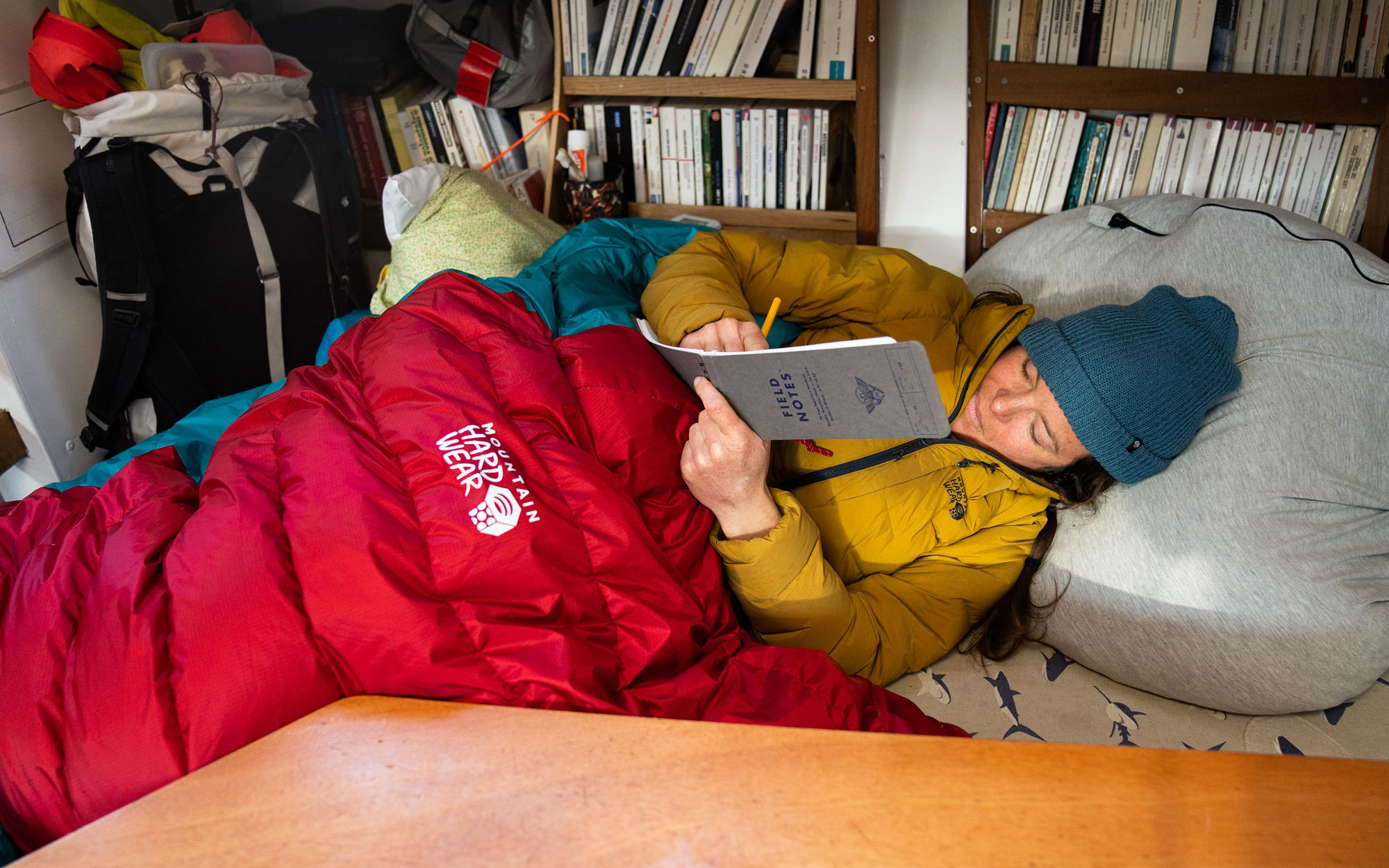 Downtime in the sailboat: Rachael is cozied up in the phantom sleeping bag while journaling.