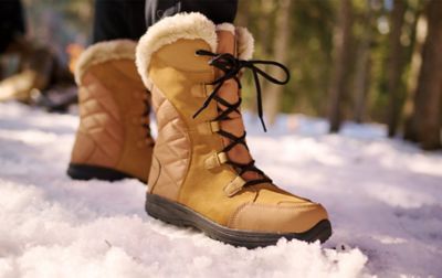 Close up of brown women's Columbia Sportswear winter boots standing in the snow. 