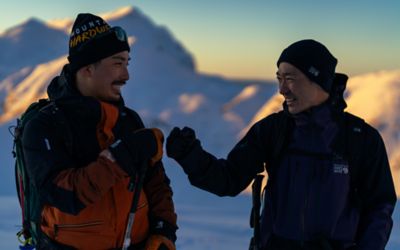 Daisuke and Keisuke fist bump and are all smiles.