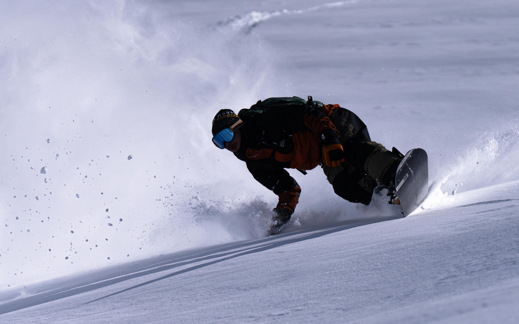 Close-up of Keisuke riding in powder on the mountain.