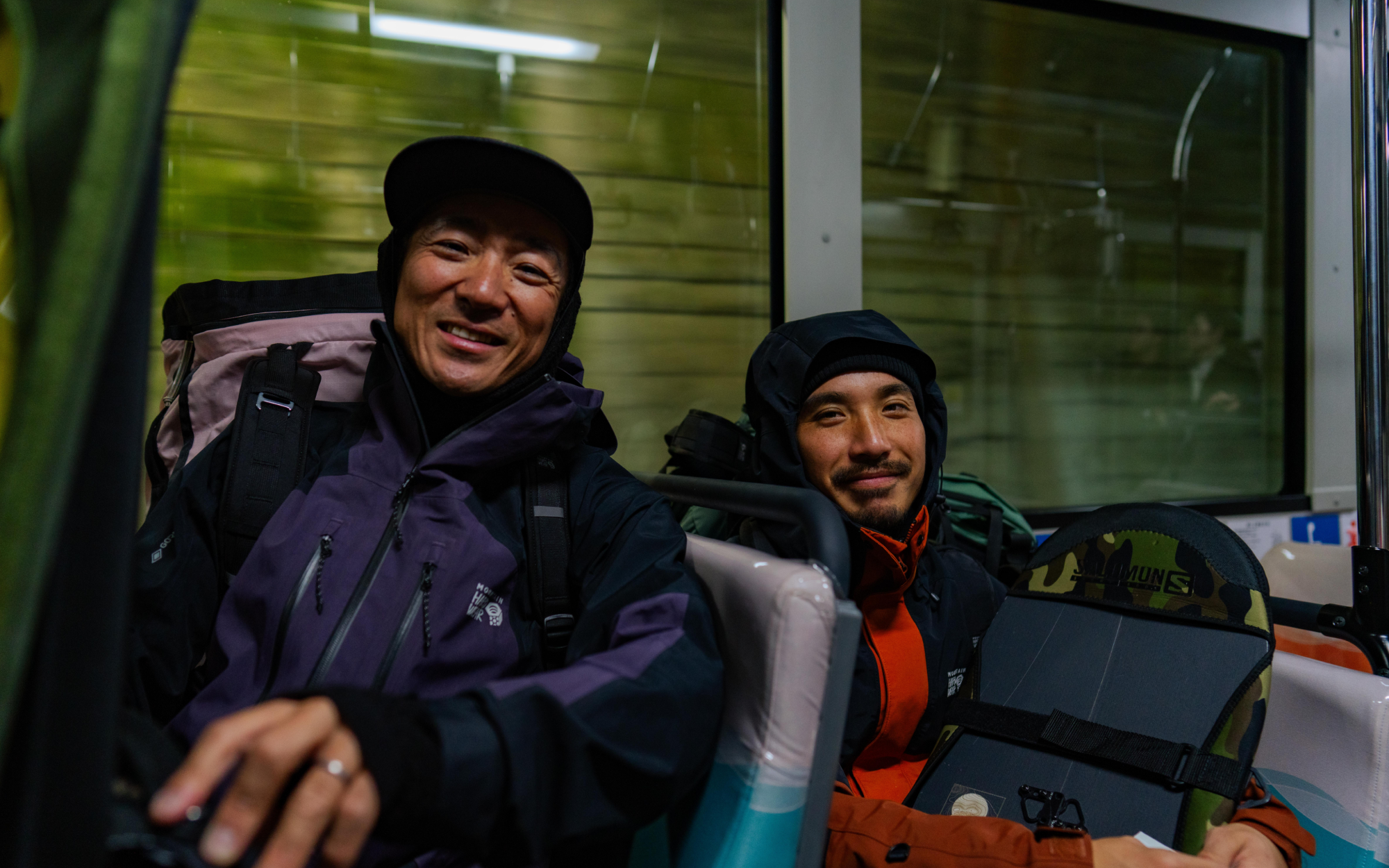 Keisuke and Daisuke riding the subway in Japan, decked out in their Mountain Hardwear ski kits.