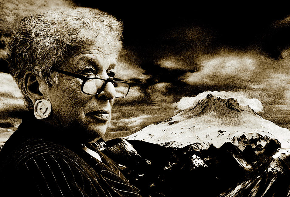Close up of Gert Boyle overlaid on a snowy mountain background. 
