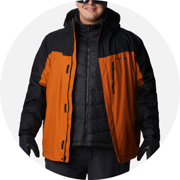 Man in an orange and black 3-in-1 ski jacket.