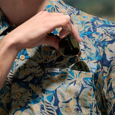 Model placing a pair of sunglasses into the chest pocket.