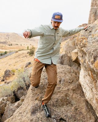 A man walking in a desert landscape.