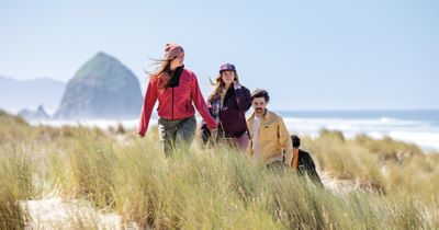 A group of friends walking along the Oregon Coast.