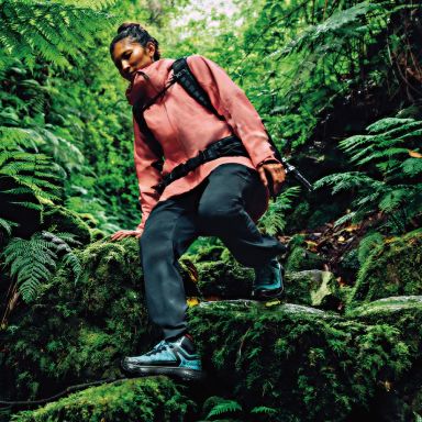 Woman hiking through a forest.