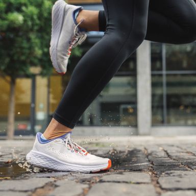 Close-up of running shoes on pavement.
