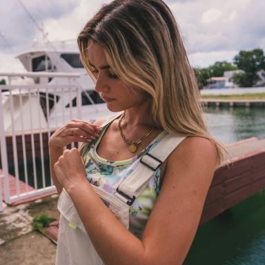 Woman in overalls on a dock.