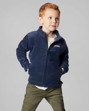 A toddler boy wearing a navy fleece jacket.