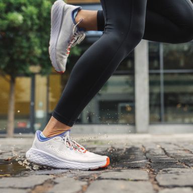 Close-up of running shoes on pavement.