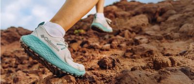 Someone in Konos hiking shoes on a trail.