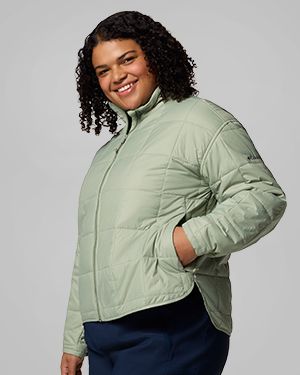 A woman wearing a light green jacket.