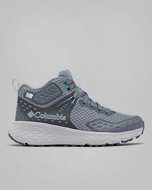 A person wearing grey hiking boots.