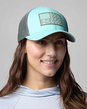 A woman wearing a teal baseball hat.