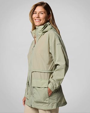 Woman wearing a light green windbreaker.