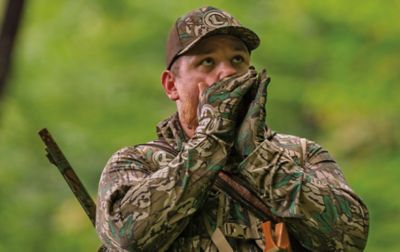 Luke Combs makes a turkey call wearing gloves that keep his hands warm, dry and protected without restricting finger dexterity.