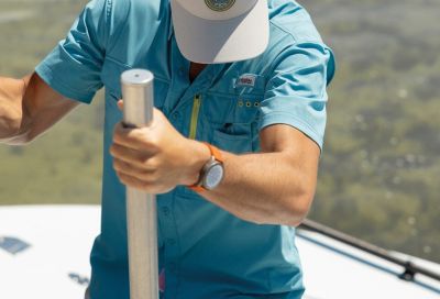 An angler climbing a boat ladder.