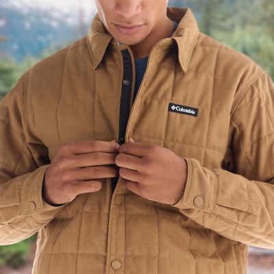 Close-up of a man buttoning a jacket.