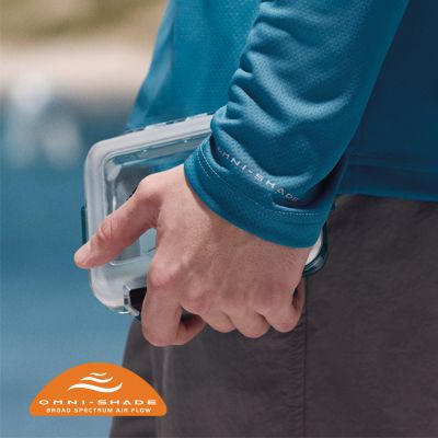 Close-up of a man holding a small fly box.