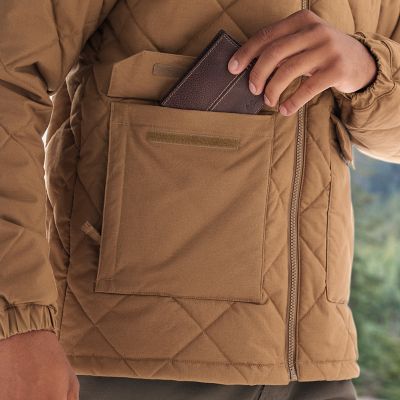 Close-up of model slipping a wallet into a large front pocket.