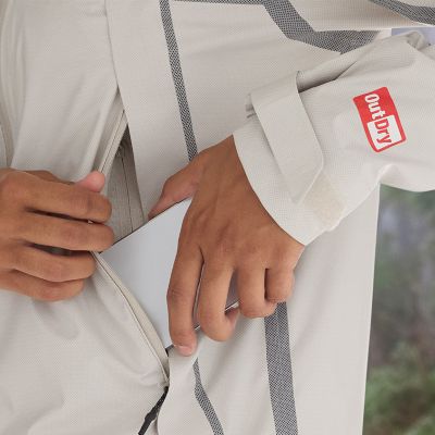 Model putting phone on zippered hand pocket.
