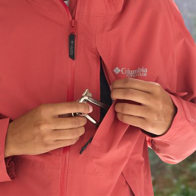 Model placing keys into the chest zip pocket.