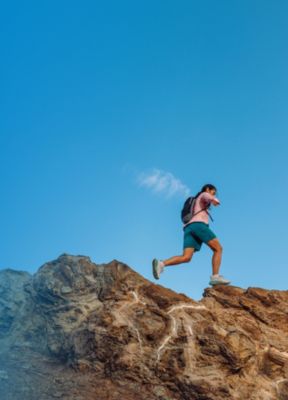 Hiker running along a ridge.