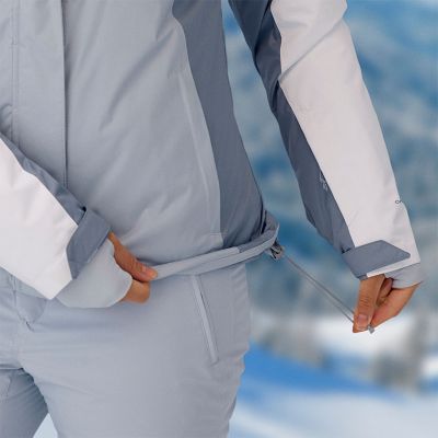 Model trekking down a slope with one knee belt, showing how the pants have a little more room in the articulated knee for easier movement.