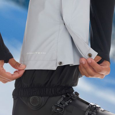 Close-up of a woman buttoning a Silver Ridge shirt. 