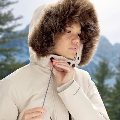 Close-up of a model adjusting the drawstring on hood.