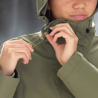 Close-up of a model adjusting the drawstring on hood.