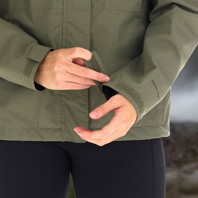 Model cinching their cuffs to seal out the elements.