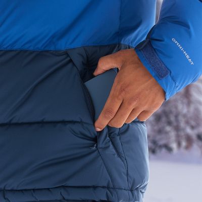 Close-up of a model slipping their phone into the hand pocket.