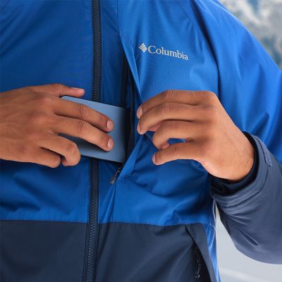 Model placing a phone into the chest zip pocket.