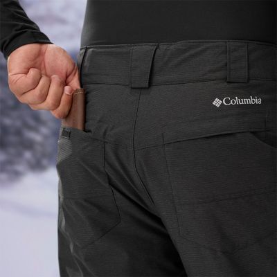 Model placing a wallet into the back pocket of the pants.