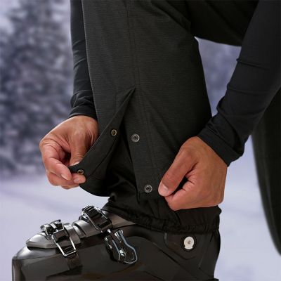 Close-up of a person snapping the leg cuffs over their boot.