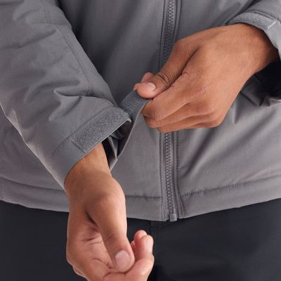 Close-up of a model adjusting the hook and loop cuffs