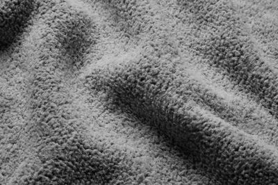 Close up of the pant's tan fabric with the Omni Wick logo in the bottom left and a graphic showing how moisture rises to the fabric's surface to evaporate in the bottom right.