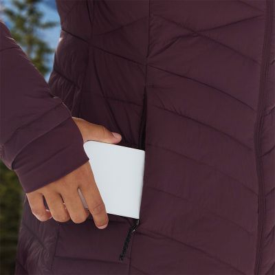 Close-up of a woman slipping their phone into the pocket