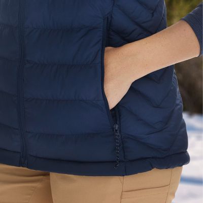 Close-up of model slipping their hand into the zippered front pocket.