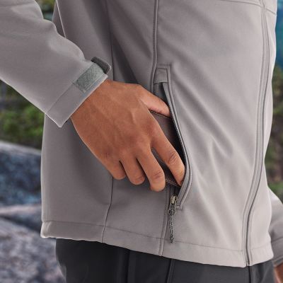 Model putting wallet into one of the zippered hand pockets.
