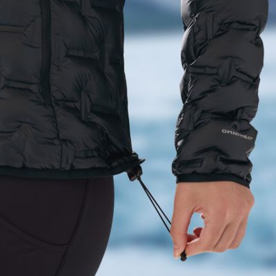 Close-up of a model slipping their phone into the zipping hand pocket.