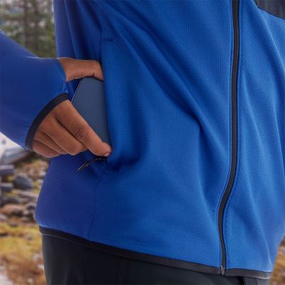 Close-up of a model putting their phone in the zipping hand pocket