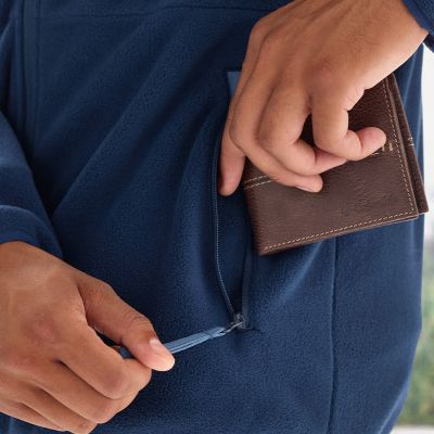 Model placing a wallet into the zippered hand pocket.
